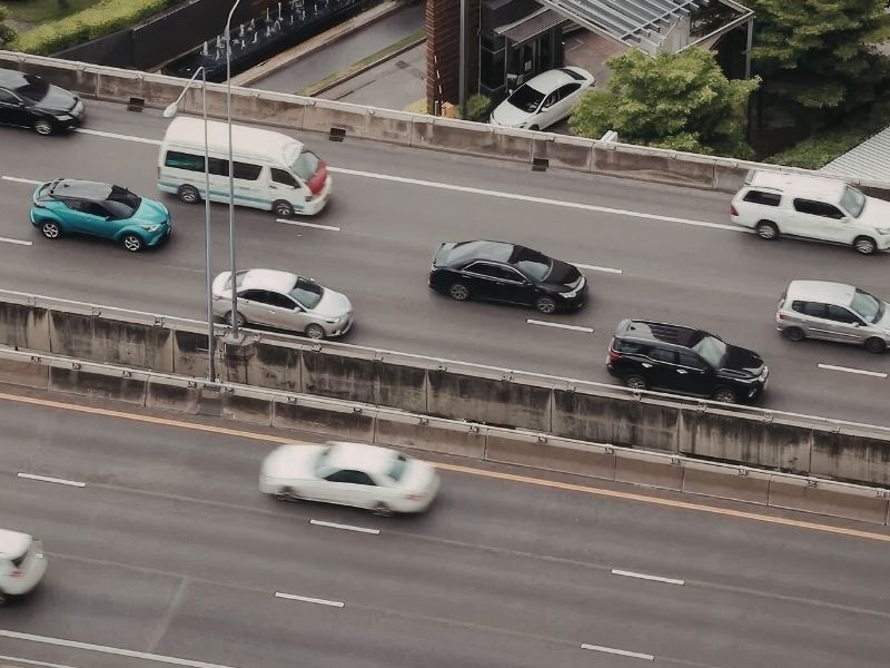 Concrete step barriers separating traffic lanes on a modern highway to improve roadway safety.